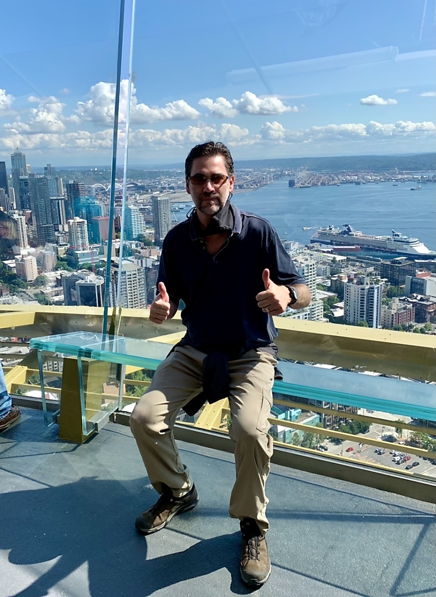 Sitting on the edge of the outdoor observation deck while visiting the Space Needle
