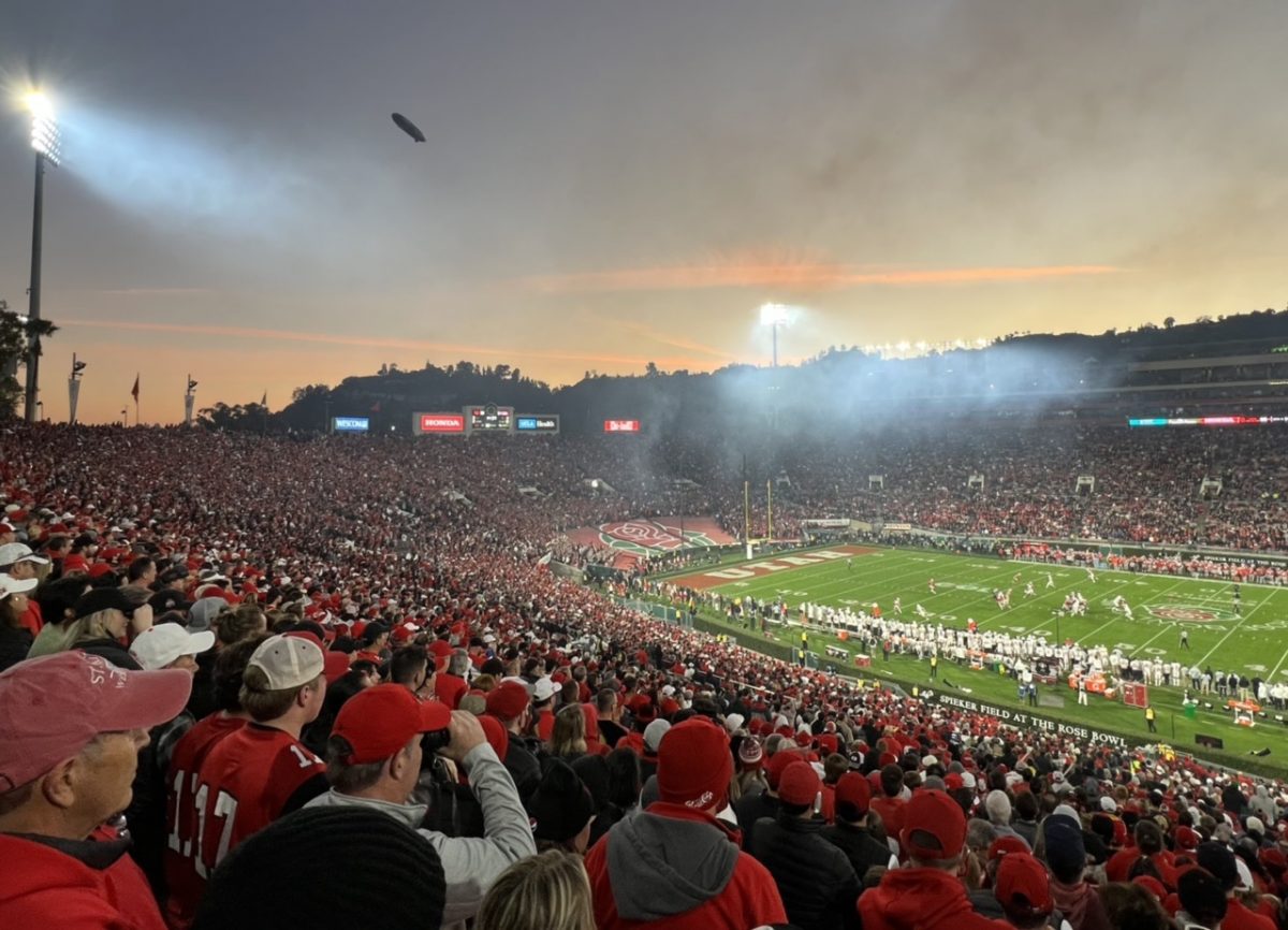 Smoke, sunset, and a blimp at Rose Bowl Stadium