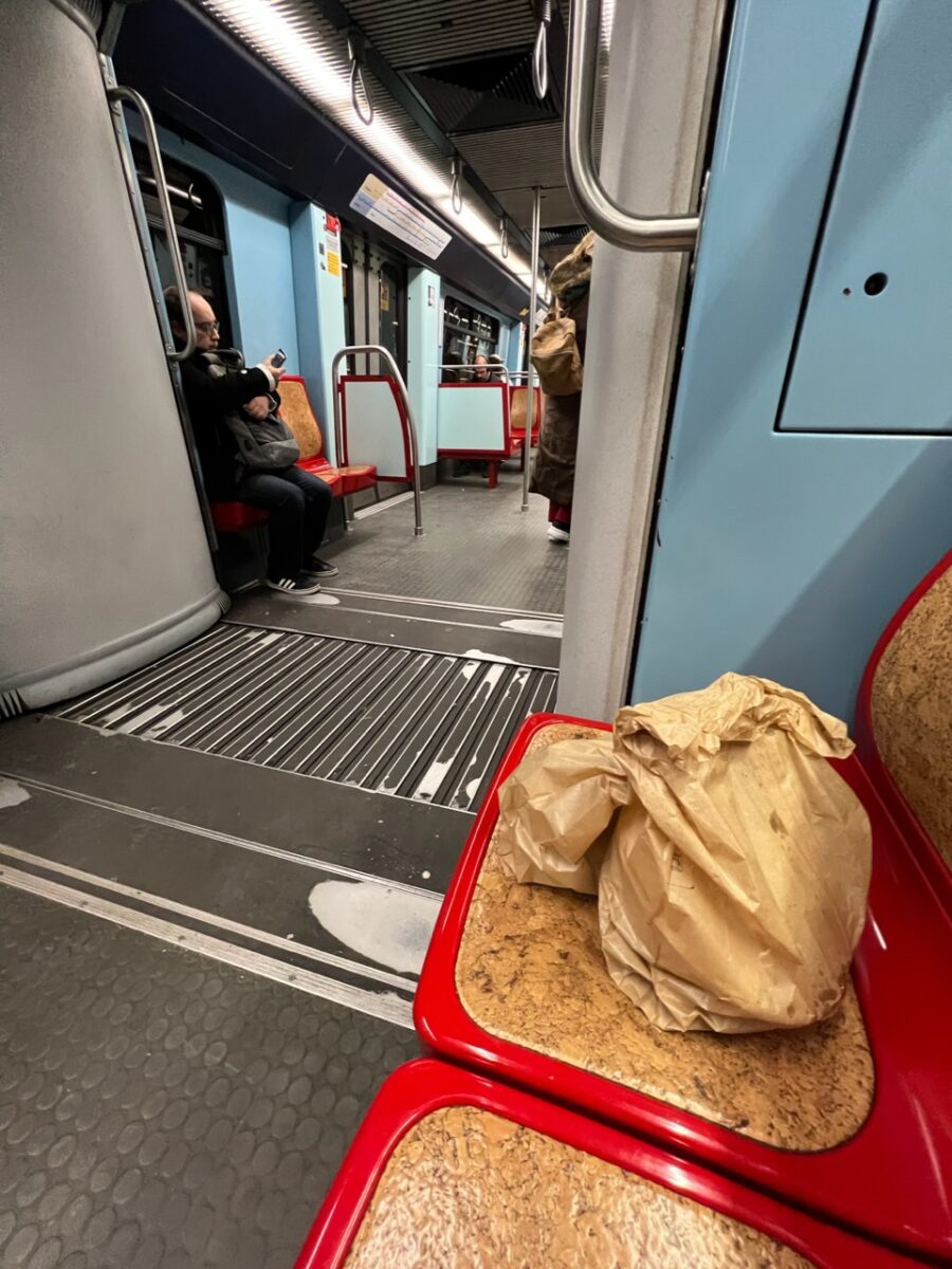A big of takout on a Metro seat in Lisbon
