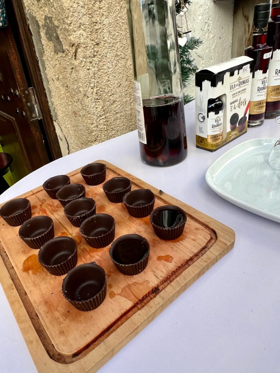 Cups made from chocolate and a bottle of the cherry liqueur Ginja along the streets of Óbidos Portugal