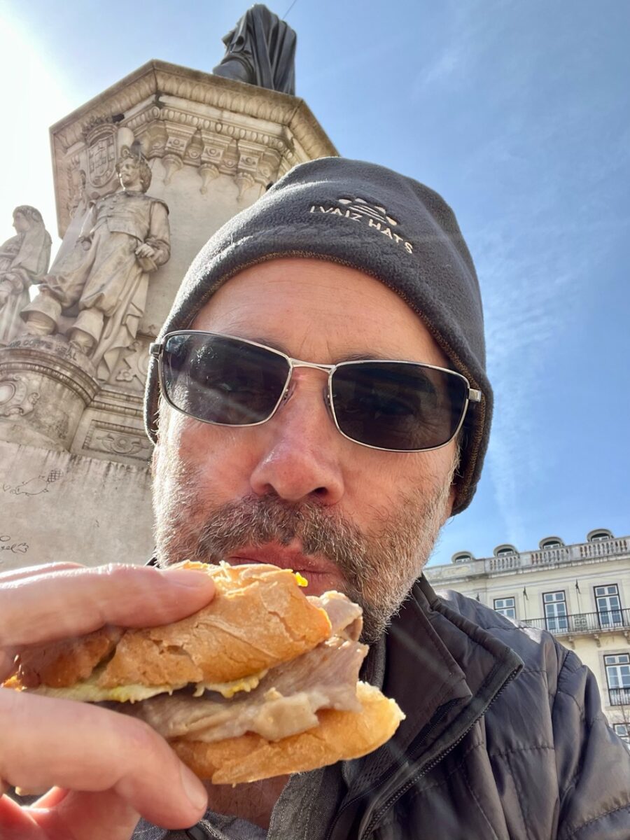 The Thorough Tripper eating a bifana sandwich from O Trevo in Lisbon