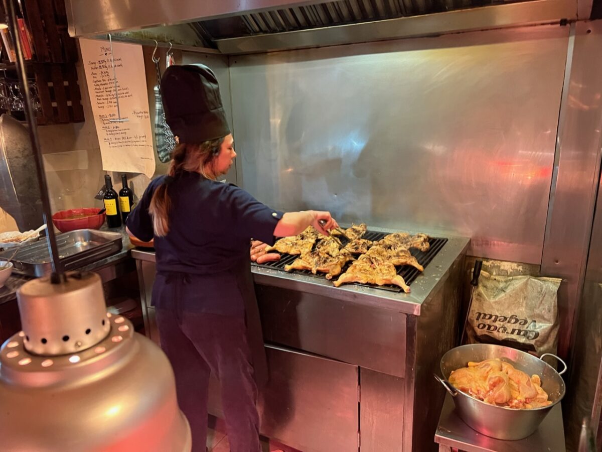 A chef prepare pir-piri chicken - on of the most common takeaway foods that you'll find if you travel to Lisbon Portugal