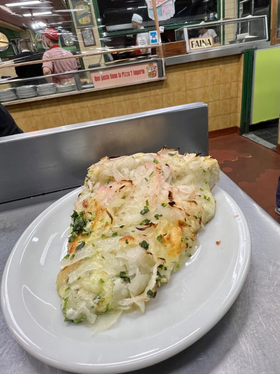 Cheese piled high on an Argentine pizza