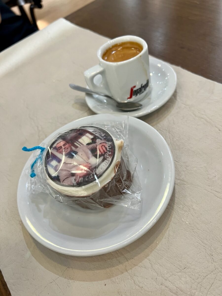 A Juan Peron decorated Alfajor along with a cup of coffee at Un Cafe con Peron