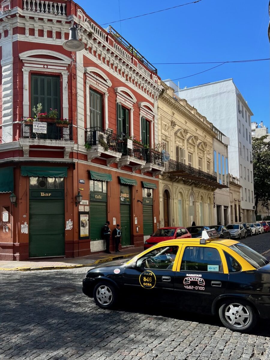 A Radio Taxi driving down the street in Buenos Aires