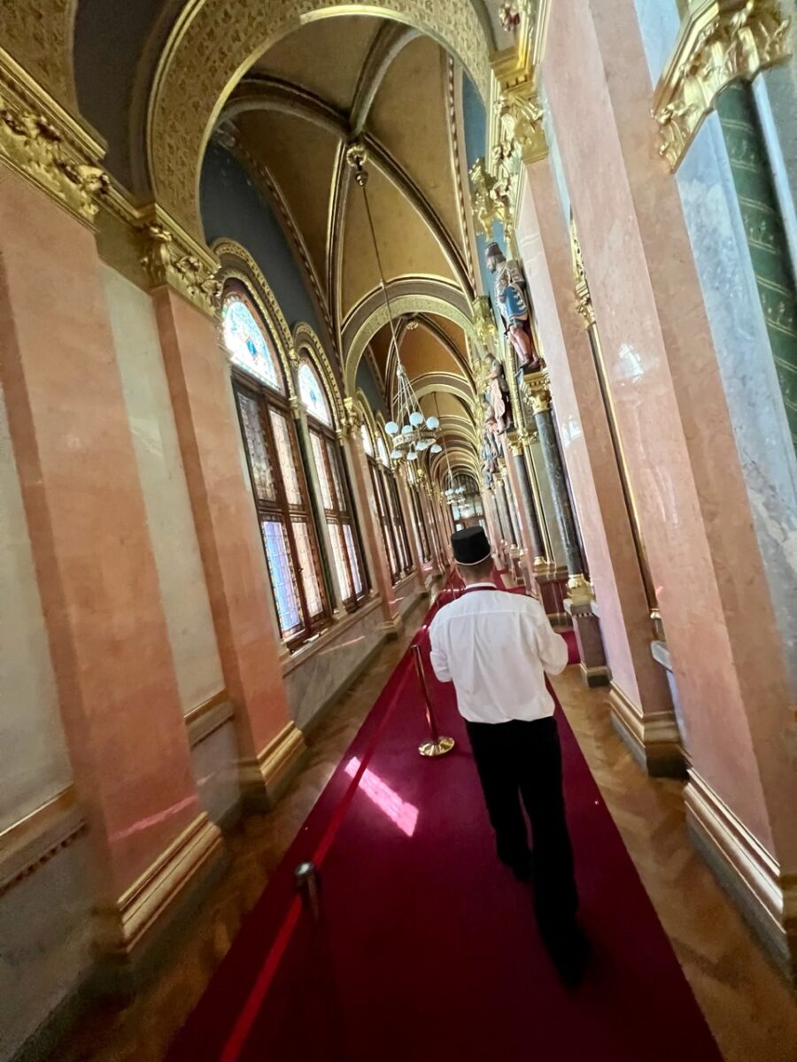 Following a guard through the decorated halls of the Hungarian Parliament