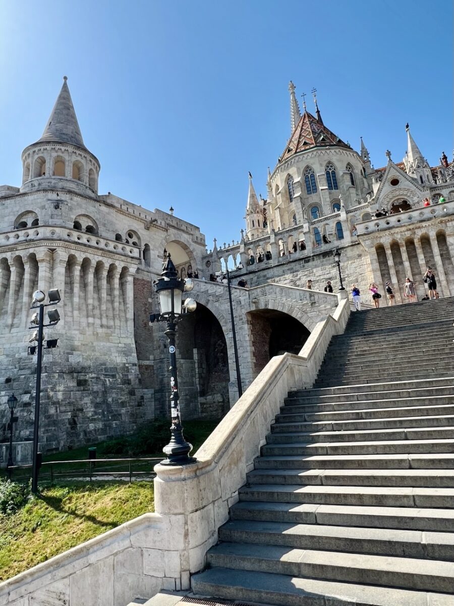 A staircase at Fisherman's Bastion with Matthias Church in the background in Budapest Hungary