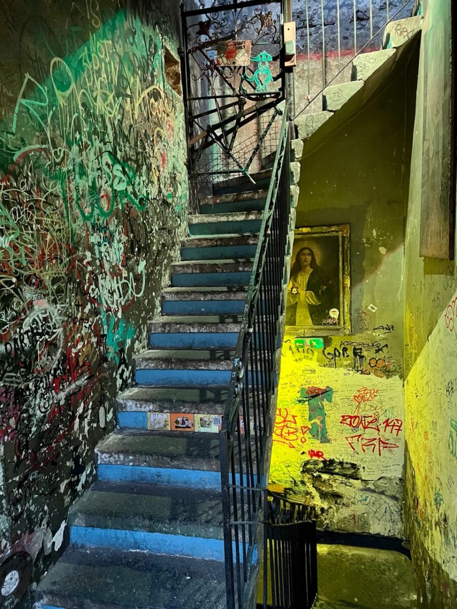 A back staircase covered in graffiti inside Szimpla Kert - the most popular Ruin Bar in Budapest Hungary