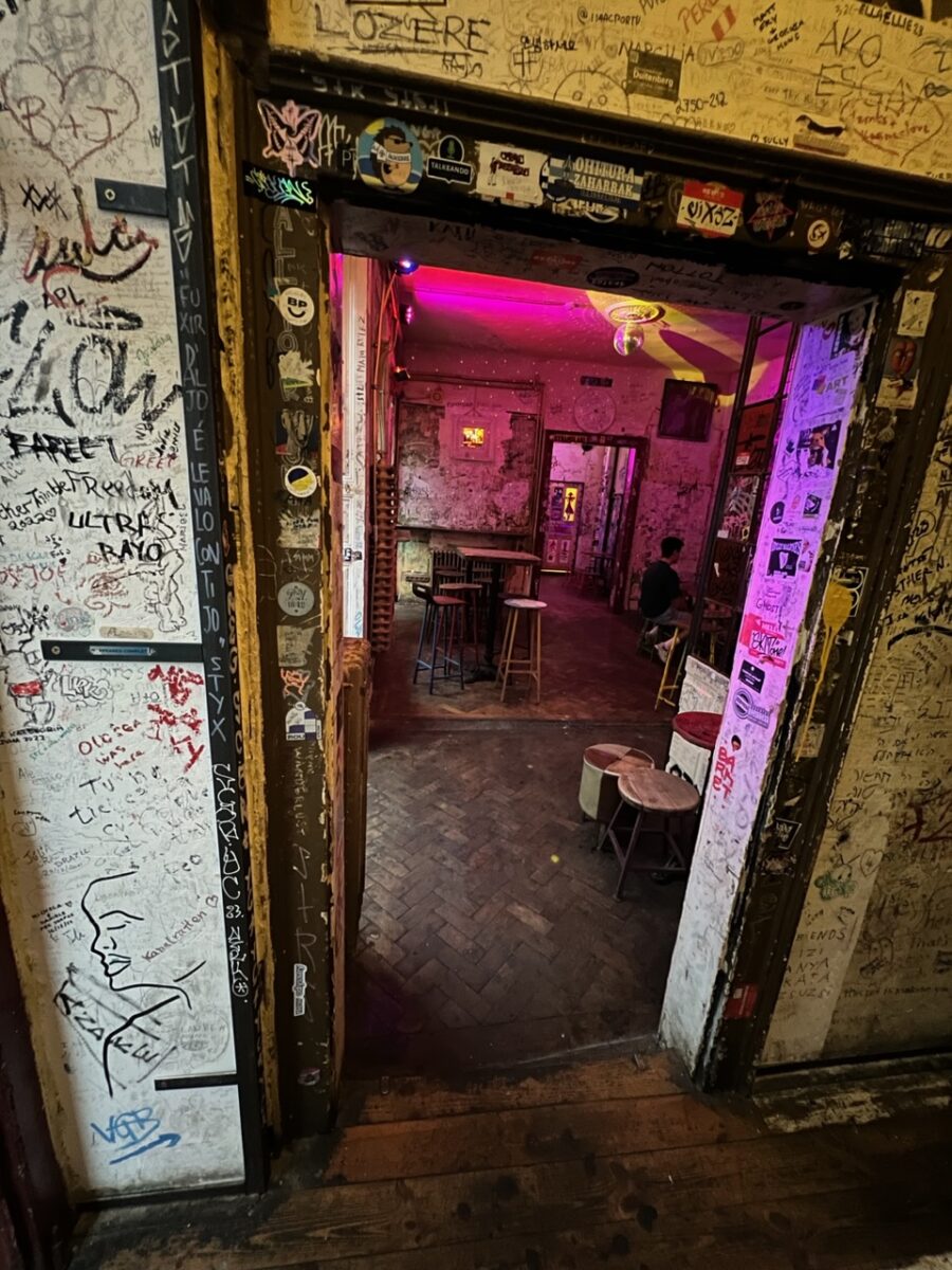 A series of rooms and doorways covered with graffiti inside Szimpla Kert - the most popular Ruin Bar in Budapest Hungary