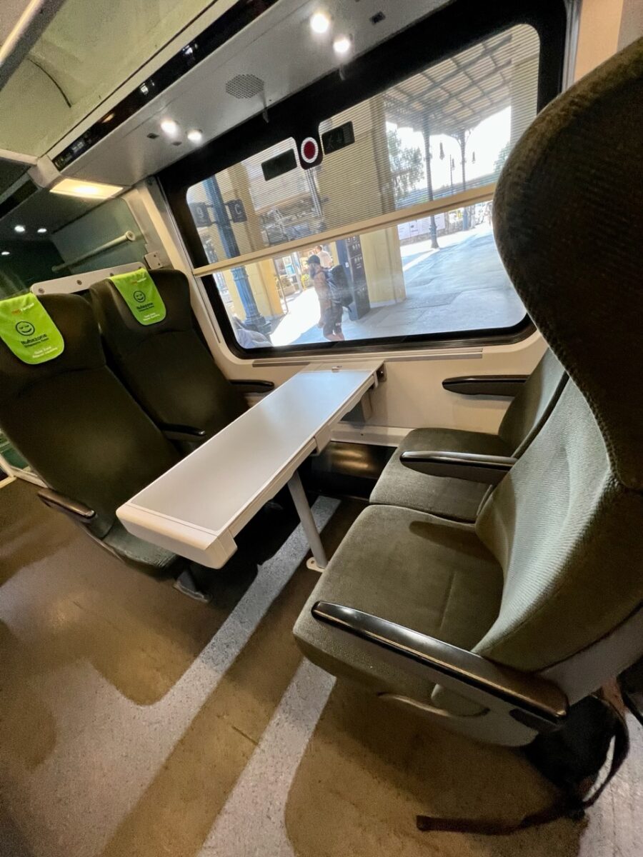 Train seats facing each other with a table in between on Austria's Railjet train