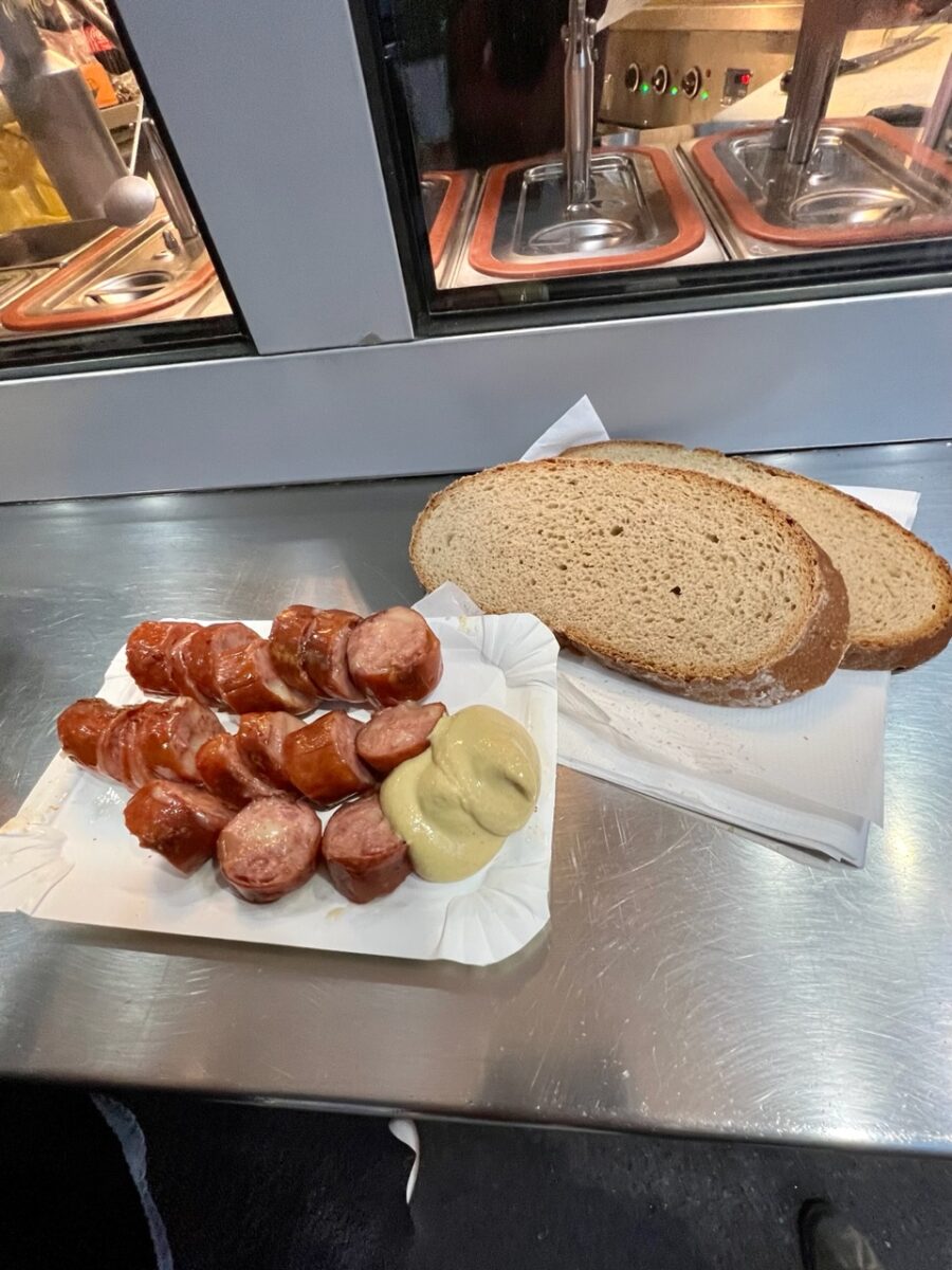 Sliced sausage, mustard, and bread at a Vienna Wurstelstand
