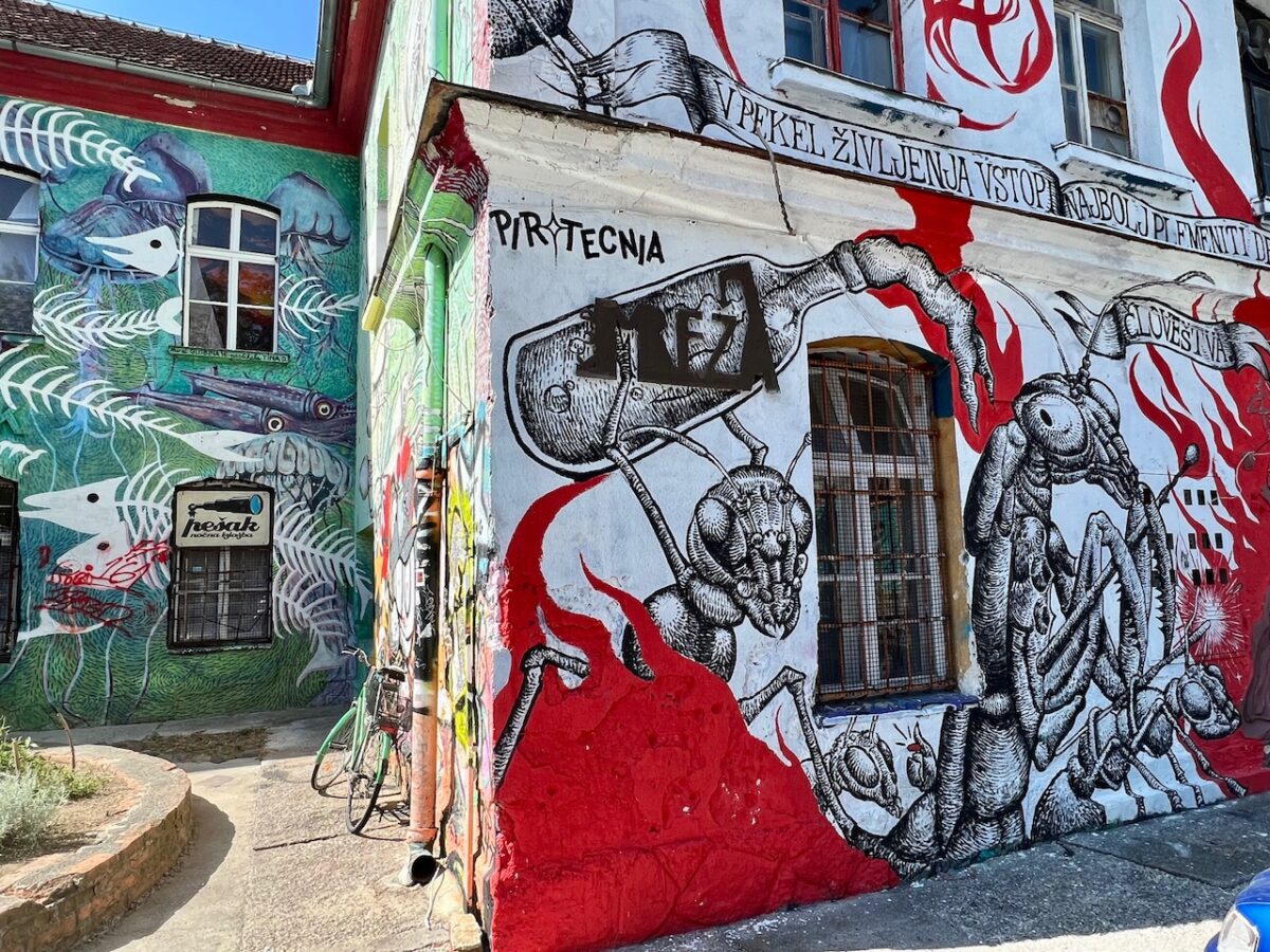 Street art covering buildings within Ljubljana's Metelkova section of town