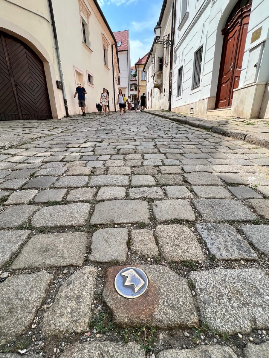 A brass crown embedded in the streets of Old Town Bratislava marking the coronation route