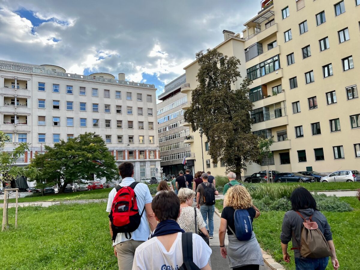 Participants walk through a city square while taking the Ljubljana Communist Walking Tour