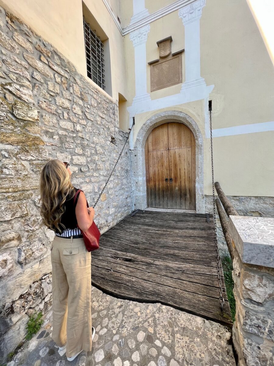 A woman approaches the drawbridge at Loka Castle in Slovenia
