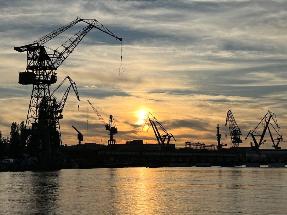 Gdańsk shipyard cranes at sunset