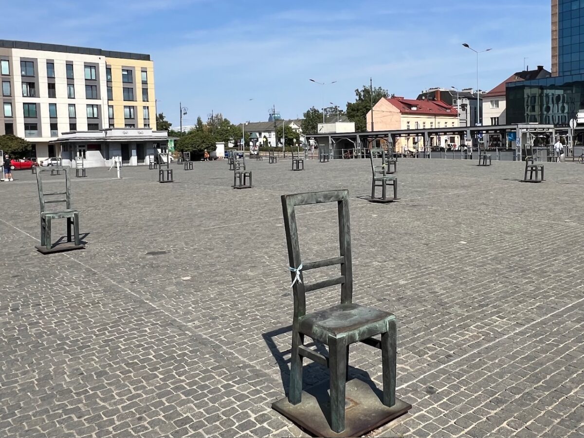Empty chairs commemorating Jewish lives lost in WWII at the Ghetto Heroes Square in Krakow Poland