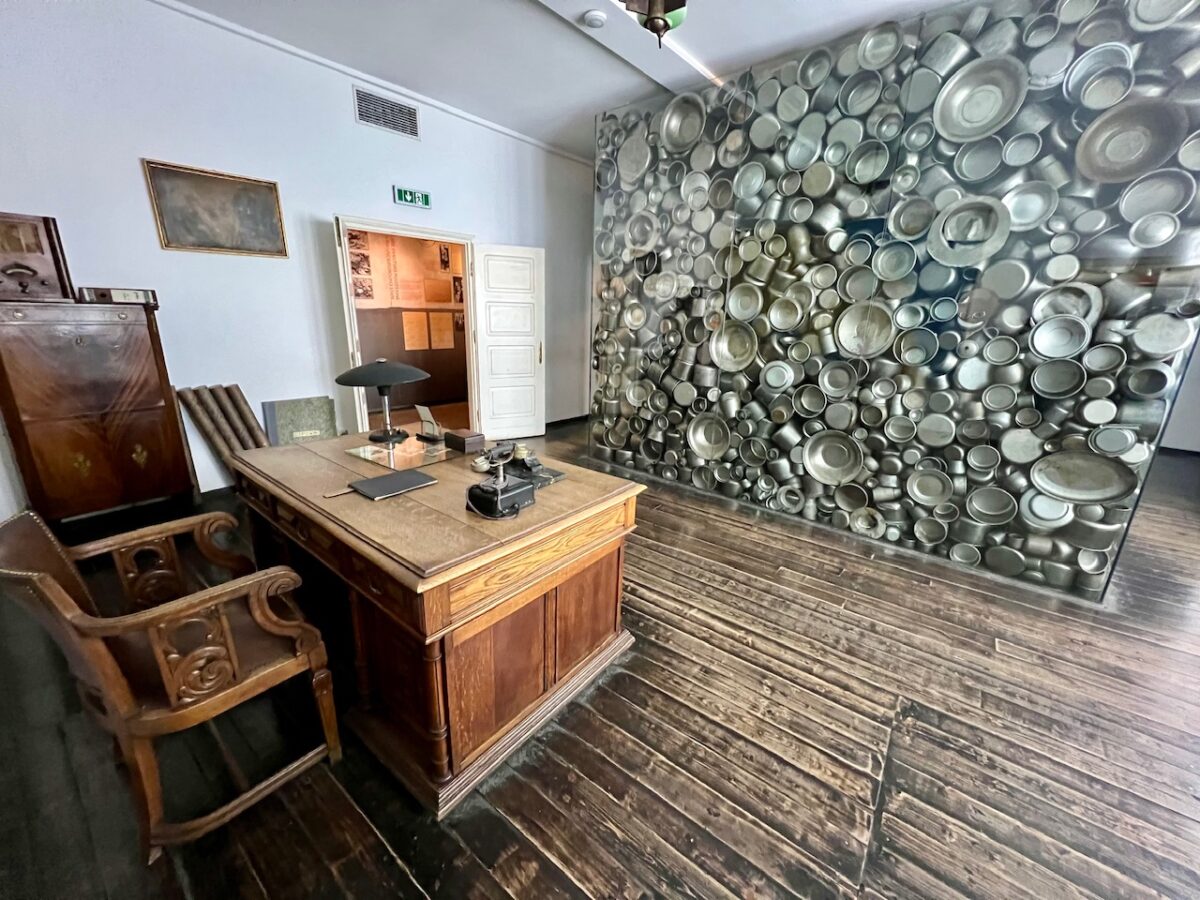 Oskar Schindler's office and a display of enamelware inside the Oskar Schindler Factory museum in Krakow