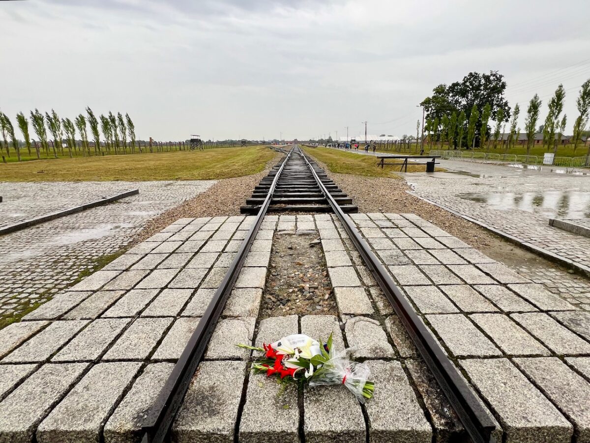 Flowers at the end of the train tracks at the Birkenau concentration camp