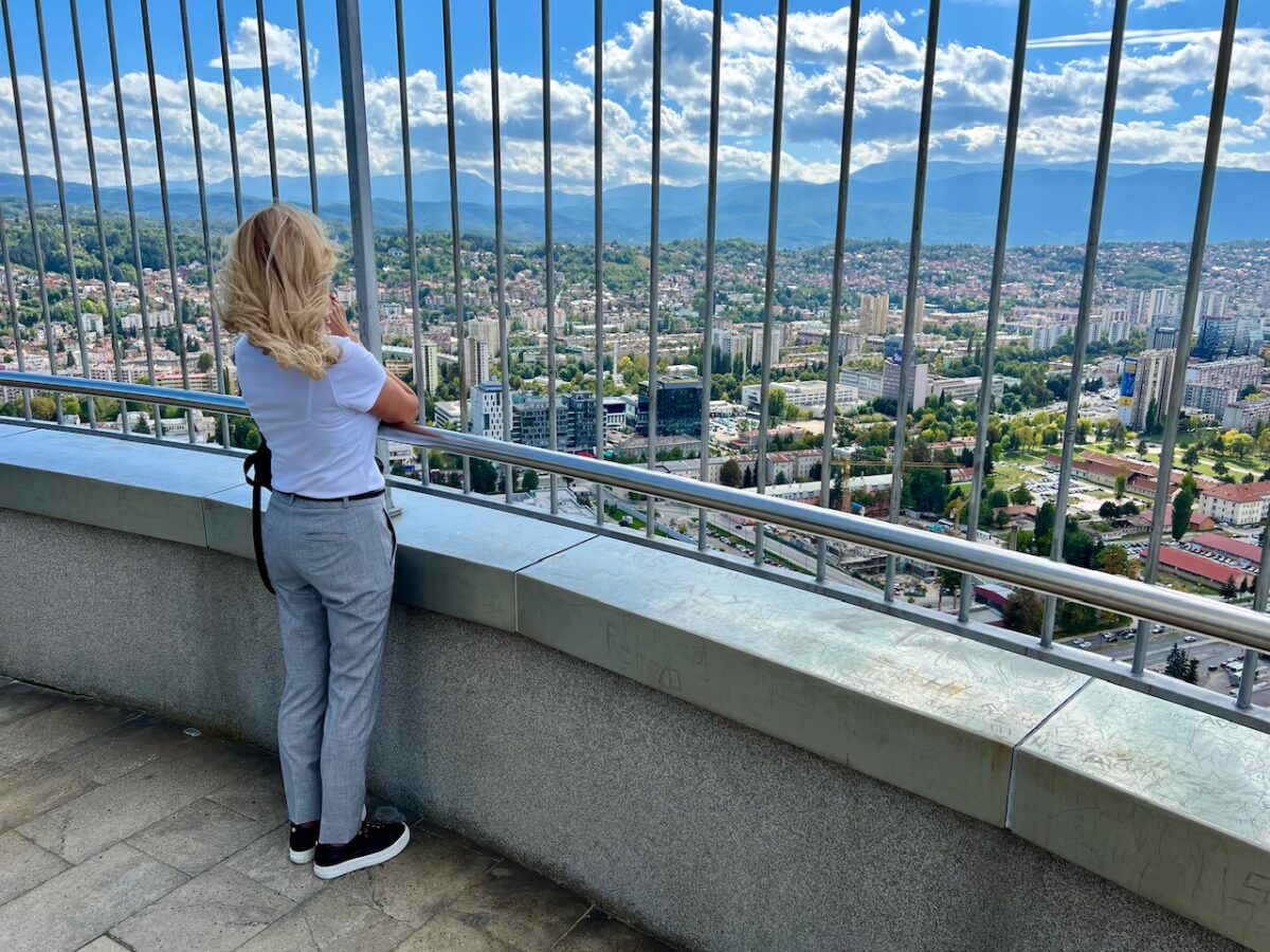 A woman takes in the view across Sarajevo from the observation deck atop the Twist Tower