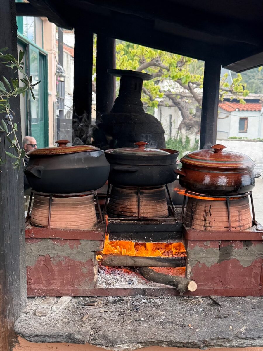 Food cooking over fire in traditional clay pots at Ntounias Taverna in Crete