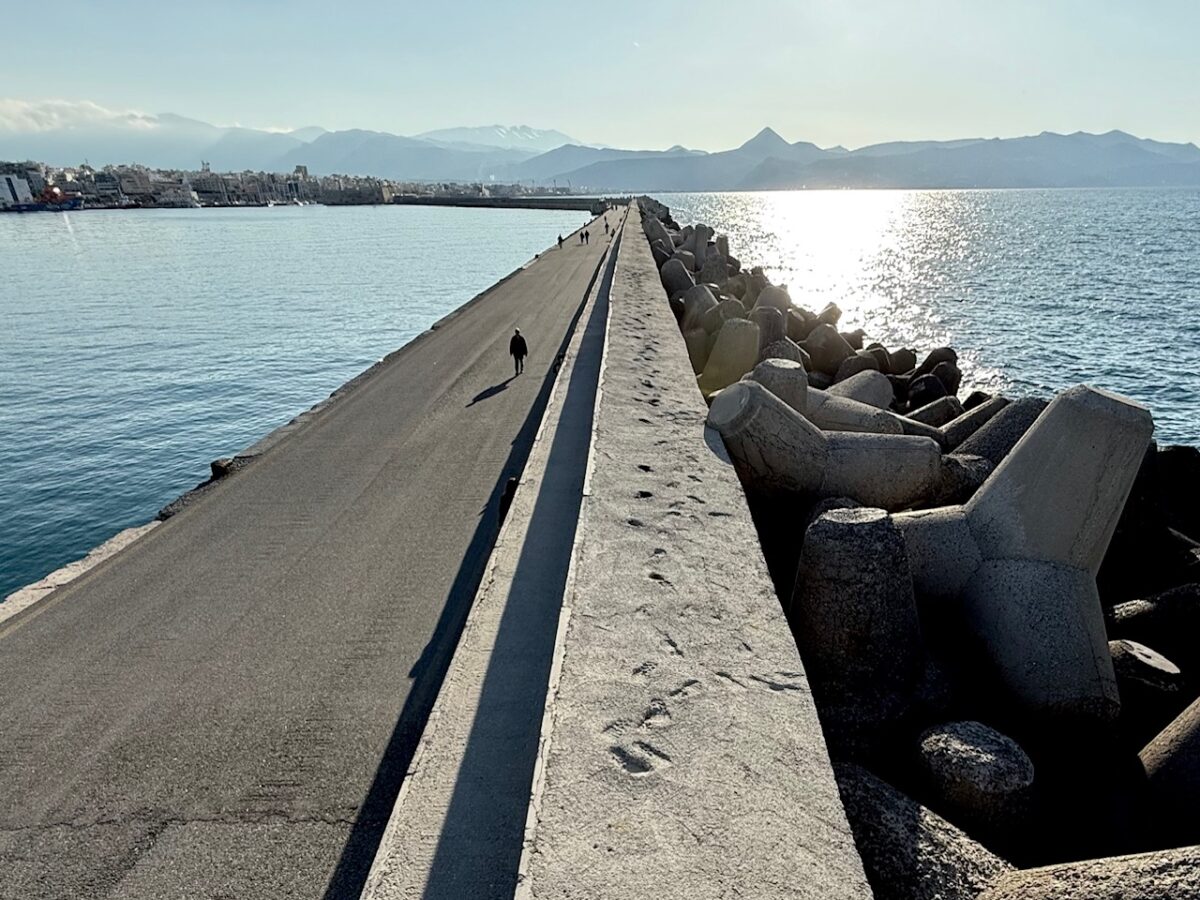Looking across both the Heraklion harbor and the Aegean Sea from atop the seawall in Heraklion Greece