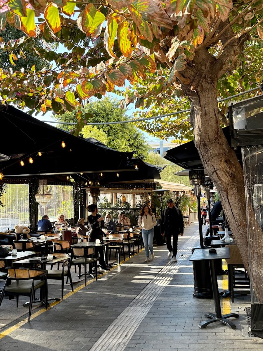 Cafes lining a shady walkway in Heraklion Crete