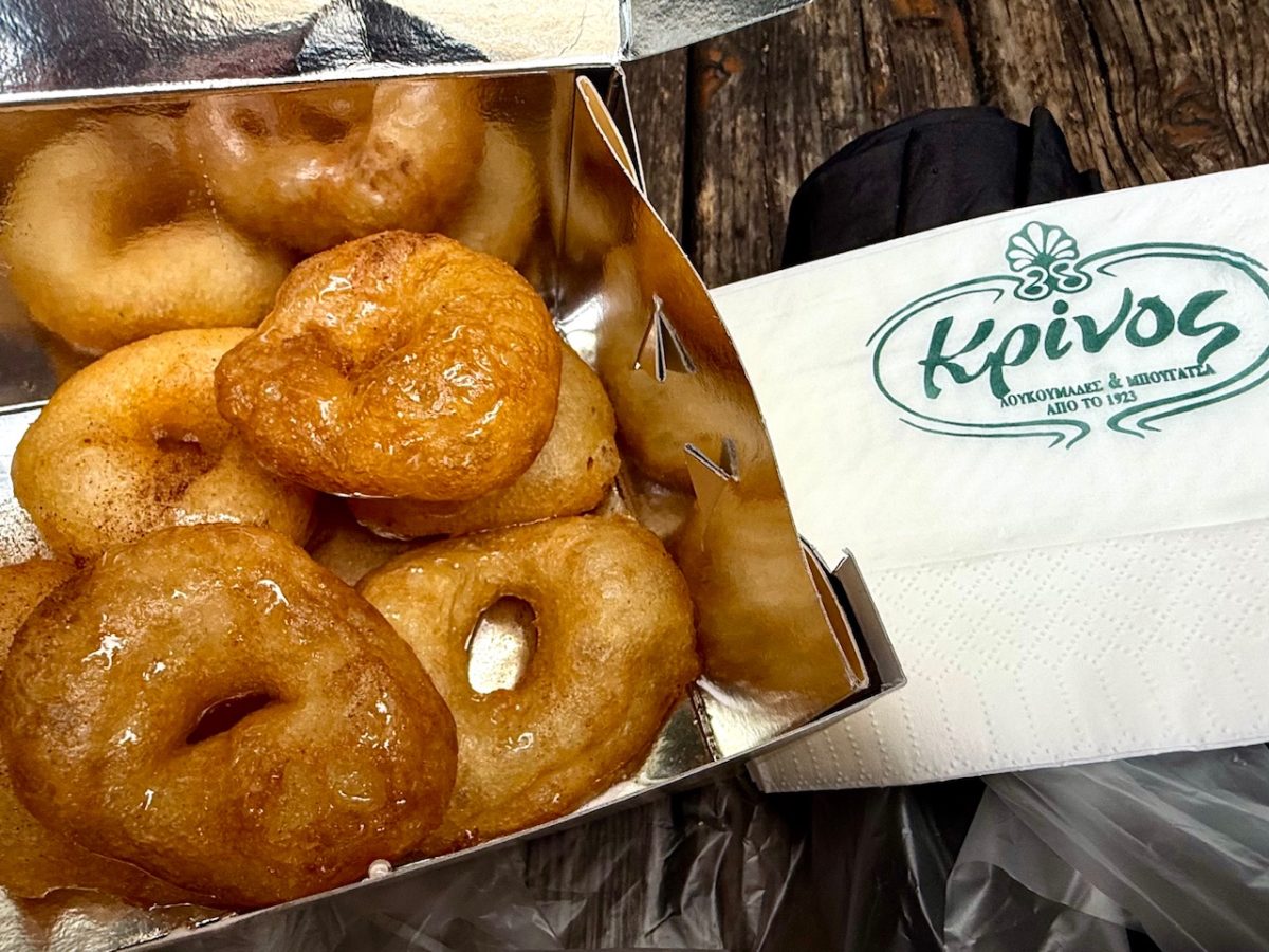 A box of loukoumades from Krinos in Athens covered in honey and cinnamon