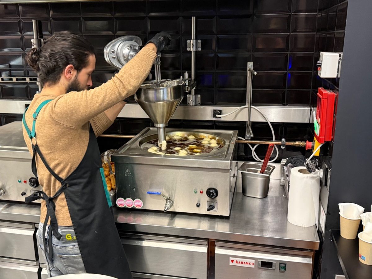 An employee making loukoumades at Loukoumadaki in Athens