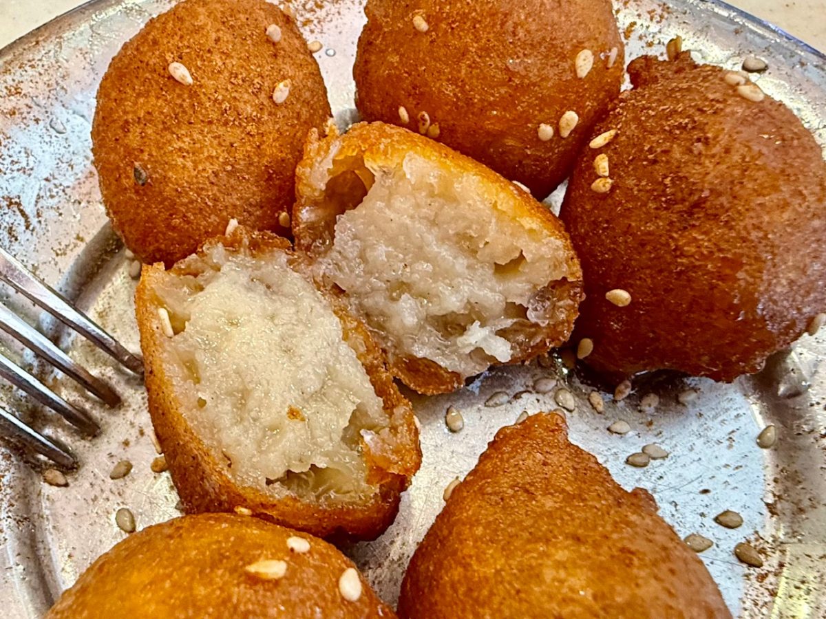 Cutting a loukoumades in half at Loukoumades Ktsstakis in Athens to reveal the syrup soaked center