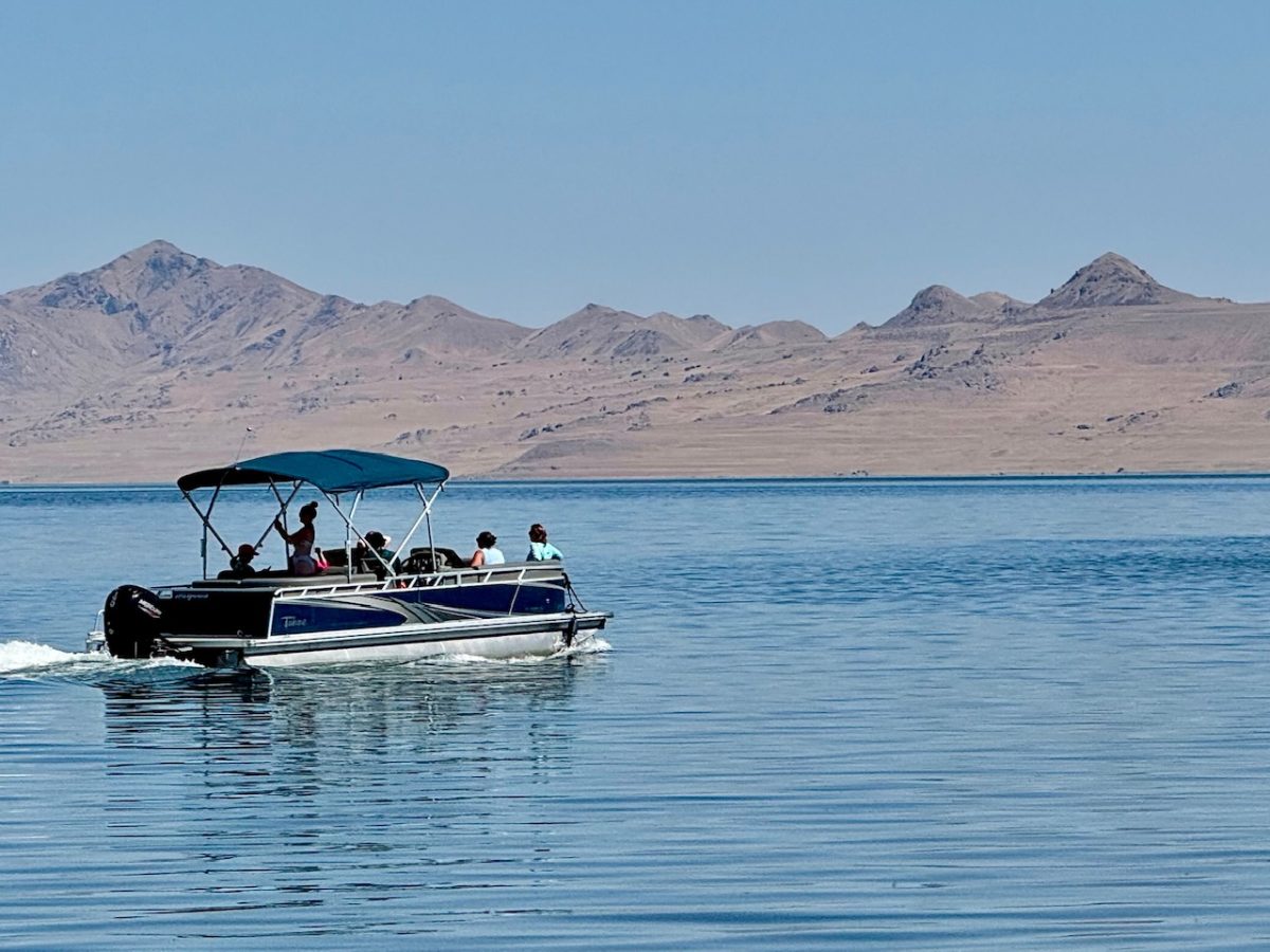 A tour boat on the Great Salt Lake with Antelope Island in the background
