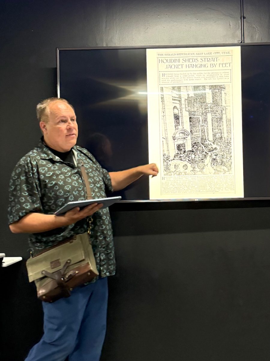A tour guide recounts the history of Harry Houdini hanging from the Walker Center doorway during a tour of the building in Salt Lake City